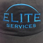 Close up image of Elite Services logo on baseball cap