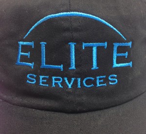 Close up image of Elite Services logo on baseball cap