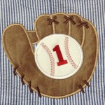 up close picture of leather glove and baseball for 1st birthday