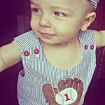 birthday boy wearing sear sucker overalls with baseball glove and ball applique with 1 on the ball