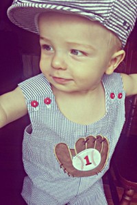 birthday boy wearing sear sucker overalls with baseball glove and ball applique with 1 on the ball