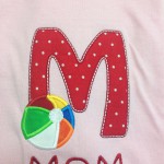 red poka dot applique M with applique beach ball in primary colors